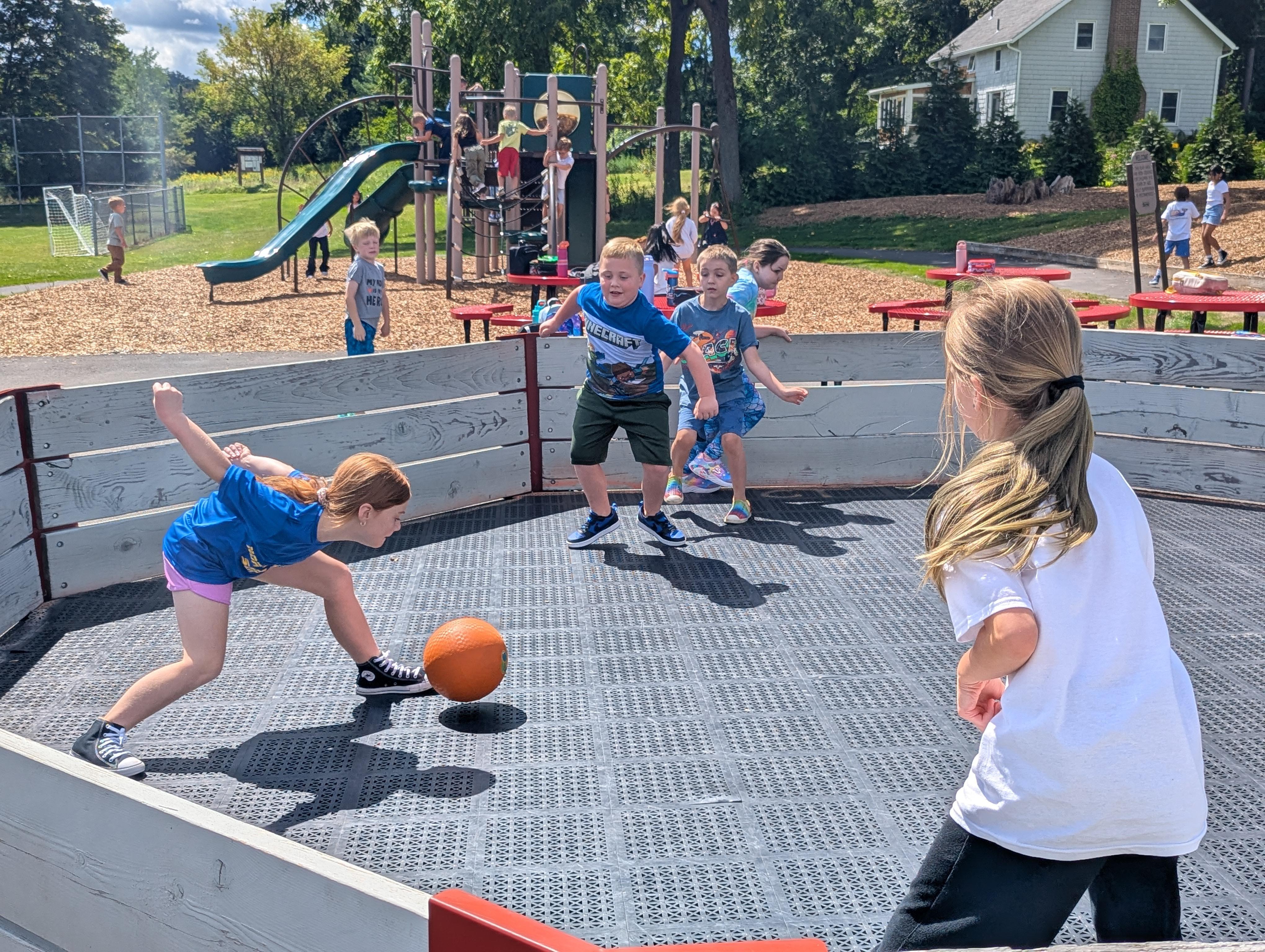 Students play gaga ball in the sunshine