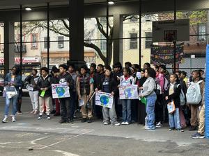 Middle school students holding their posters during the pep rally