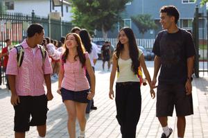 Four Whittier Union students walk together and smile as they arrive on campus on the first day of the school year on August 12.