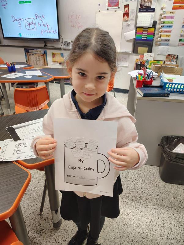 A second grade student displays her cup of calm.