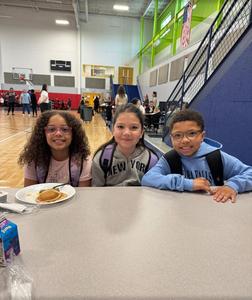 Picture of LHS students eating breakfast in the gymnasium.