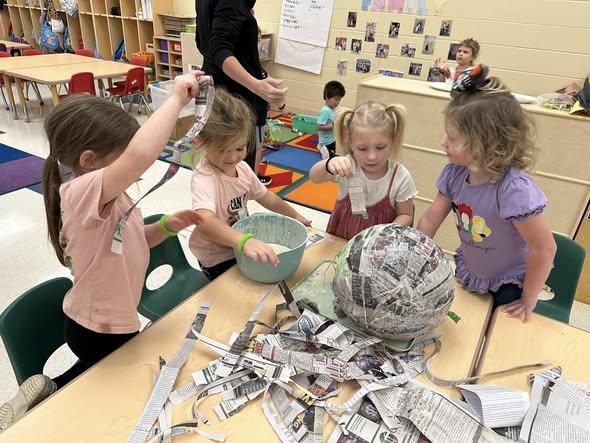 In Prek students read “Hooray, A Piñata!” over the last few weeks so we made a paper mache piñata, filled it, discussed and figured out how to hang and fill it, then smashed it open for Halloween.