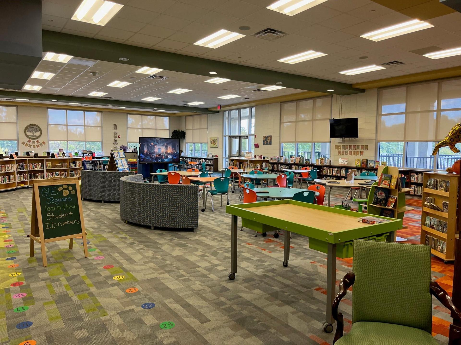 Grovetown Learning Commons space including tables, chairs, and shelves of books.