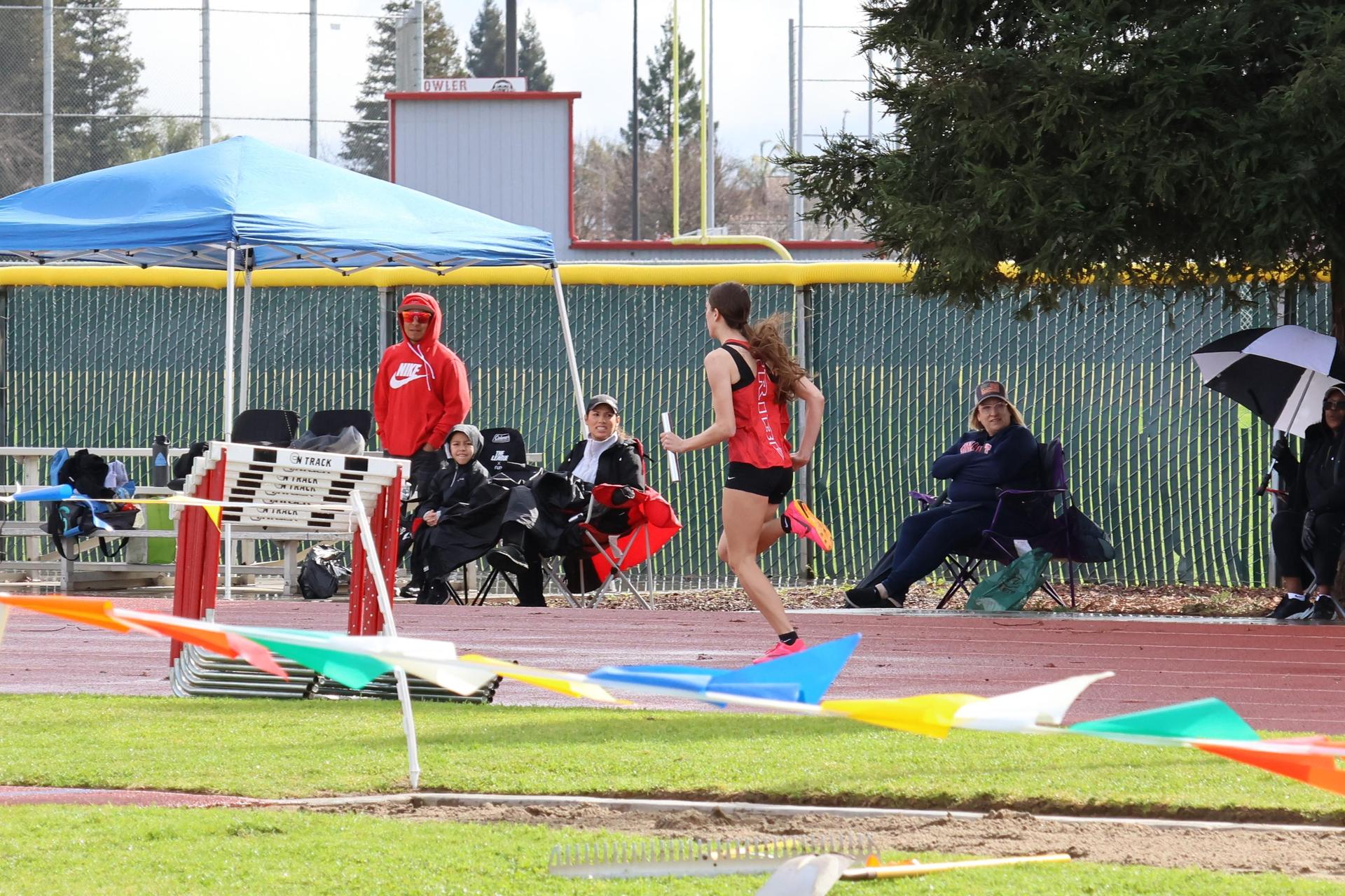 girls running the four by 100 meter relay