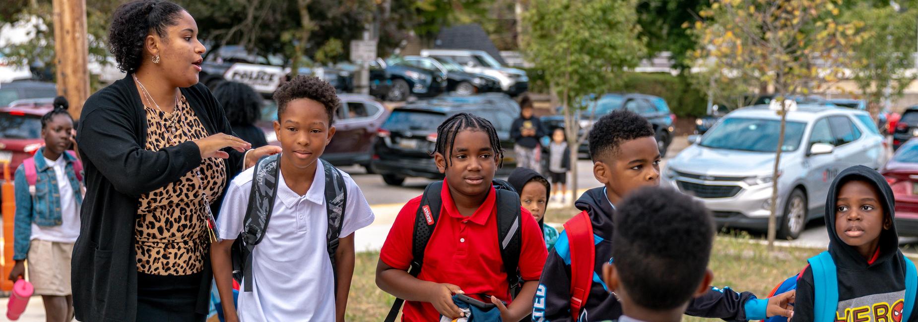 Students walk to school with a teacher