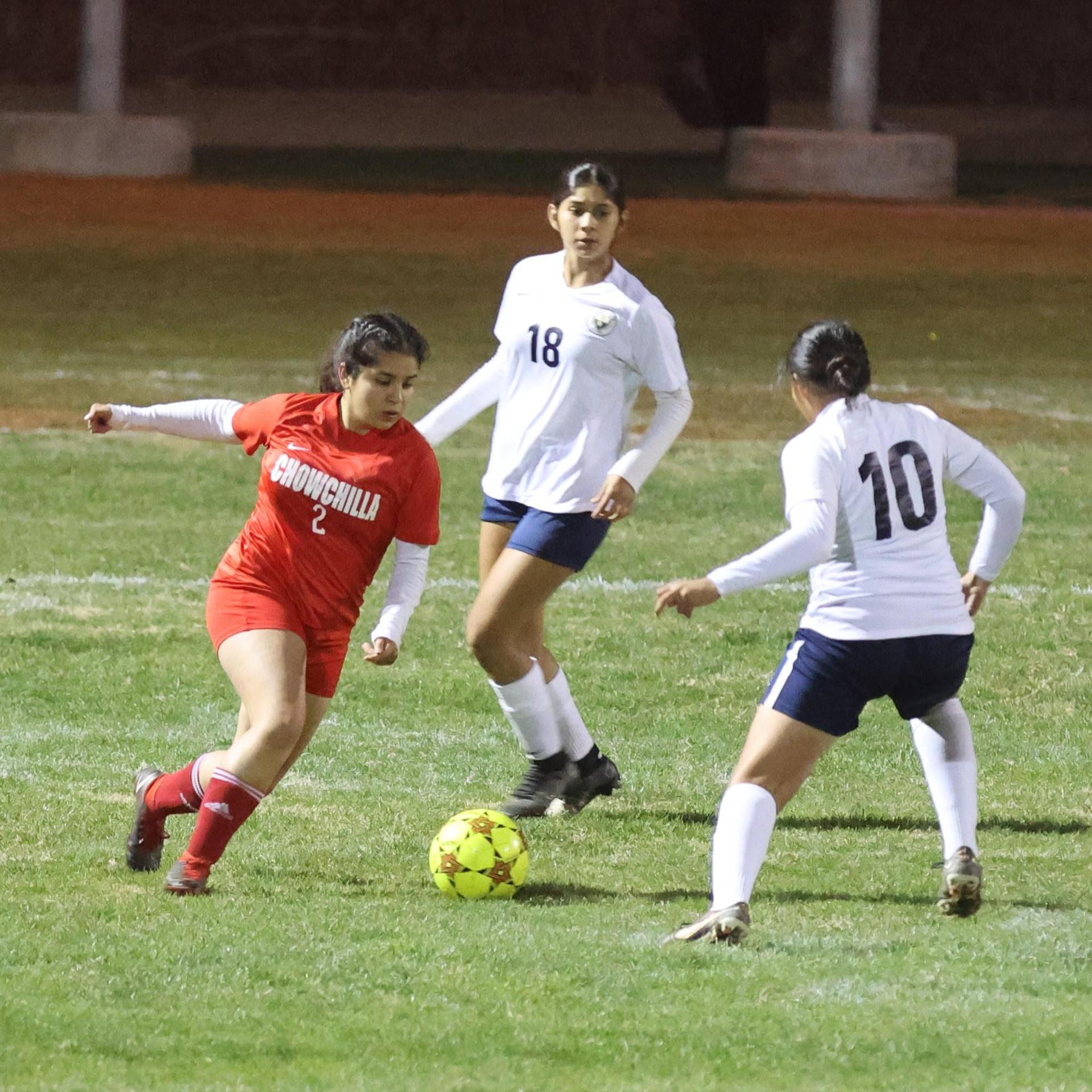 Varsity girls playing soccer against sunnyside