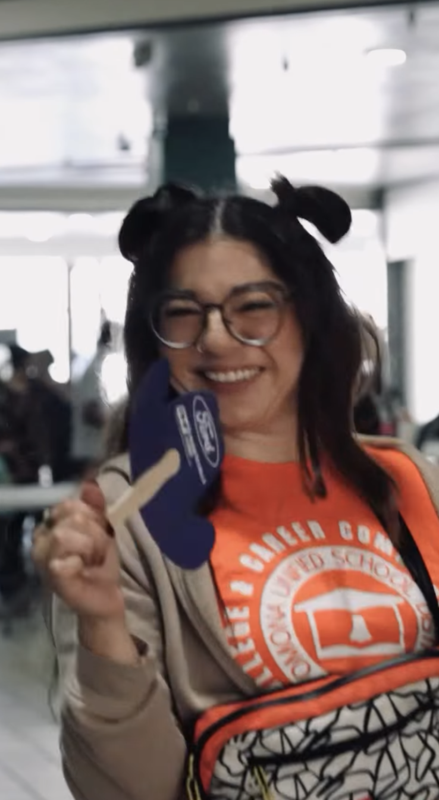 staff fanning a community day prop