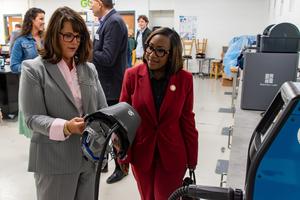 Delegate Kimberly Pope Adams (right) learns about the GO TEC welding station with Courtney Massengill (left), a GO TEC training coordinator, which uses augmented reality to simulate welding without the need for real-life units, while allowing students to learn essential skills in the always-in-demand career sector.