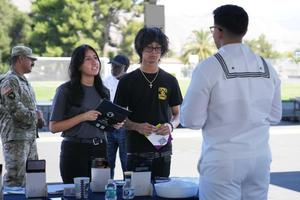 students talk with Navy recruiter