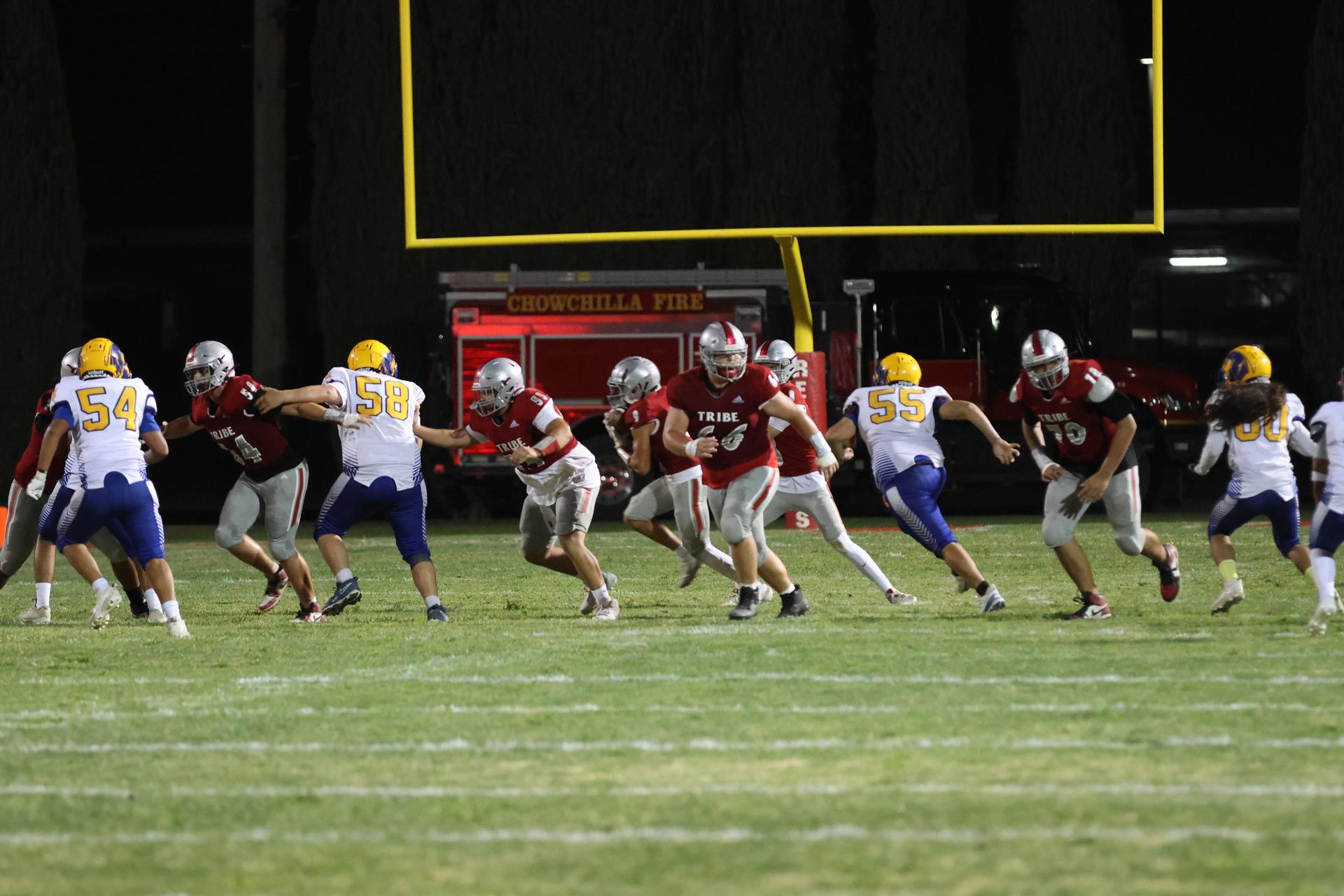 Varsity football players in action against Parlier 20