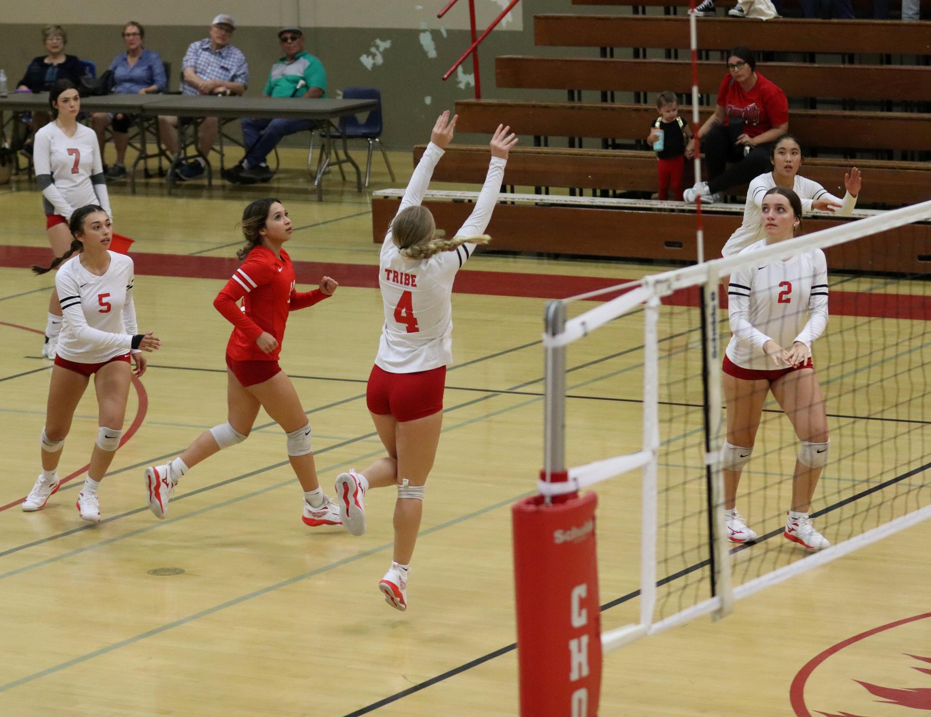 varsity volleyball players in action against liberty