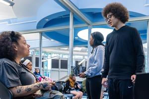 Joy talks with one of the student poets