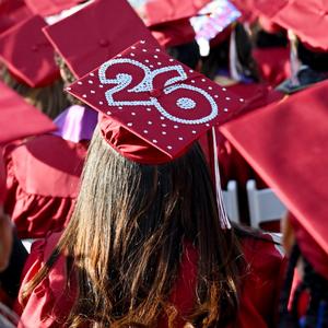 Back view of a graduate's cap decorated with pearls and the number 26.