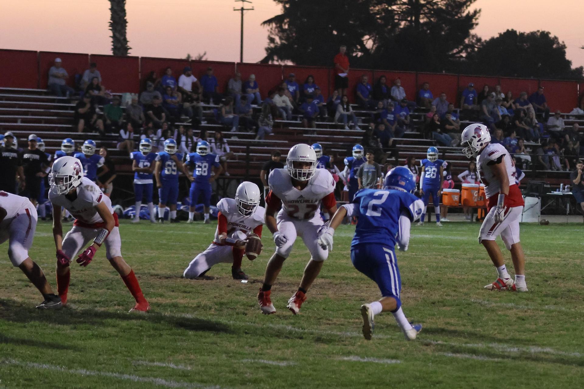 Junior Varsity football players in action against Caruthers