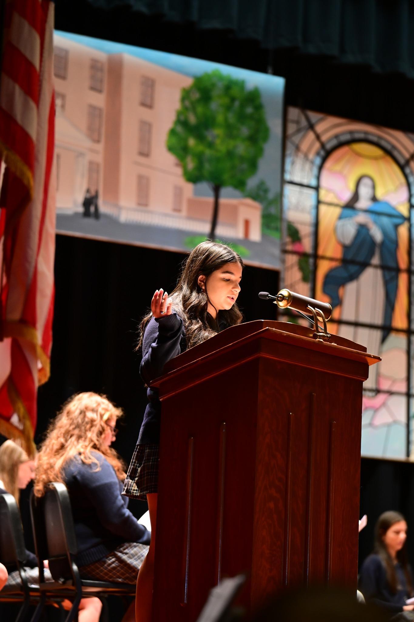 A Student Leads Prayer During A Mass