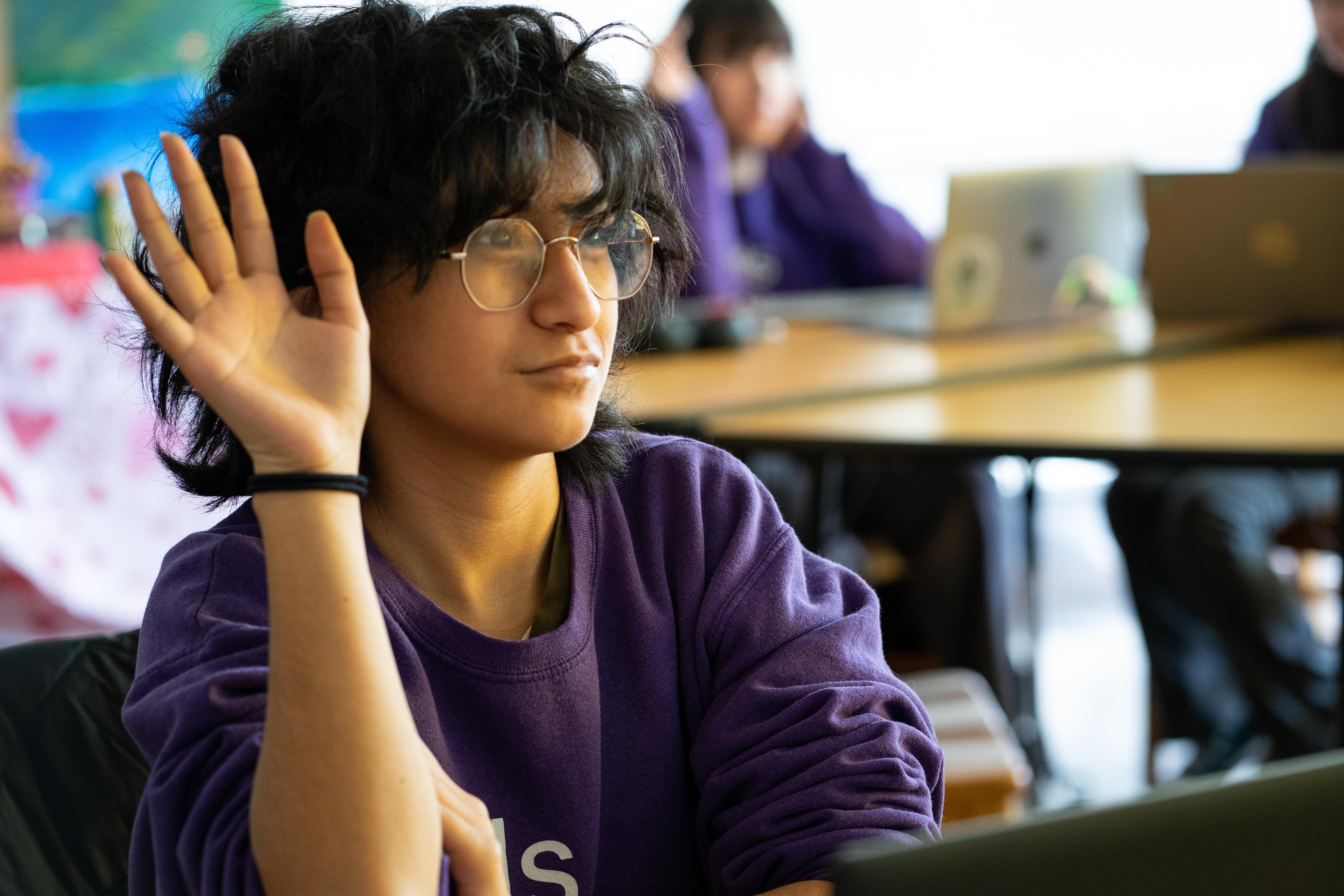 Student raising hand in class