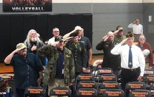 Veterans salute as the National Anthem is played.