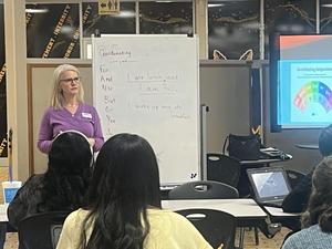 English/reading instructor speaks to students in the Commons