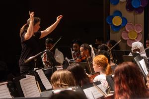 Ms. Burgh conducts