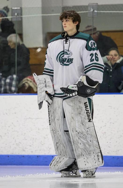 Logan  Caron on the ice in his goalie's uniform