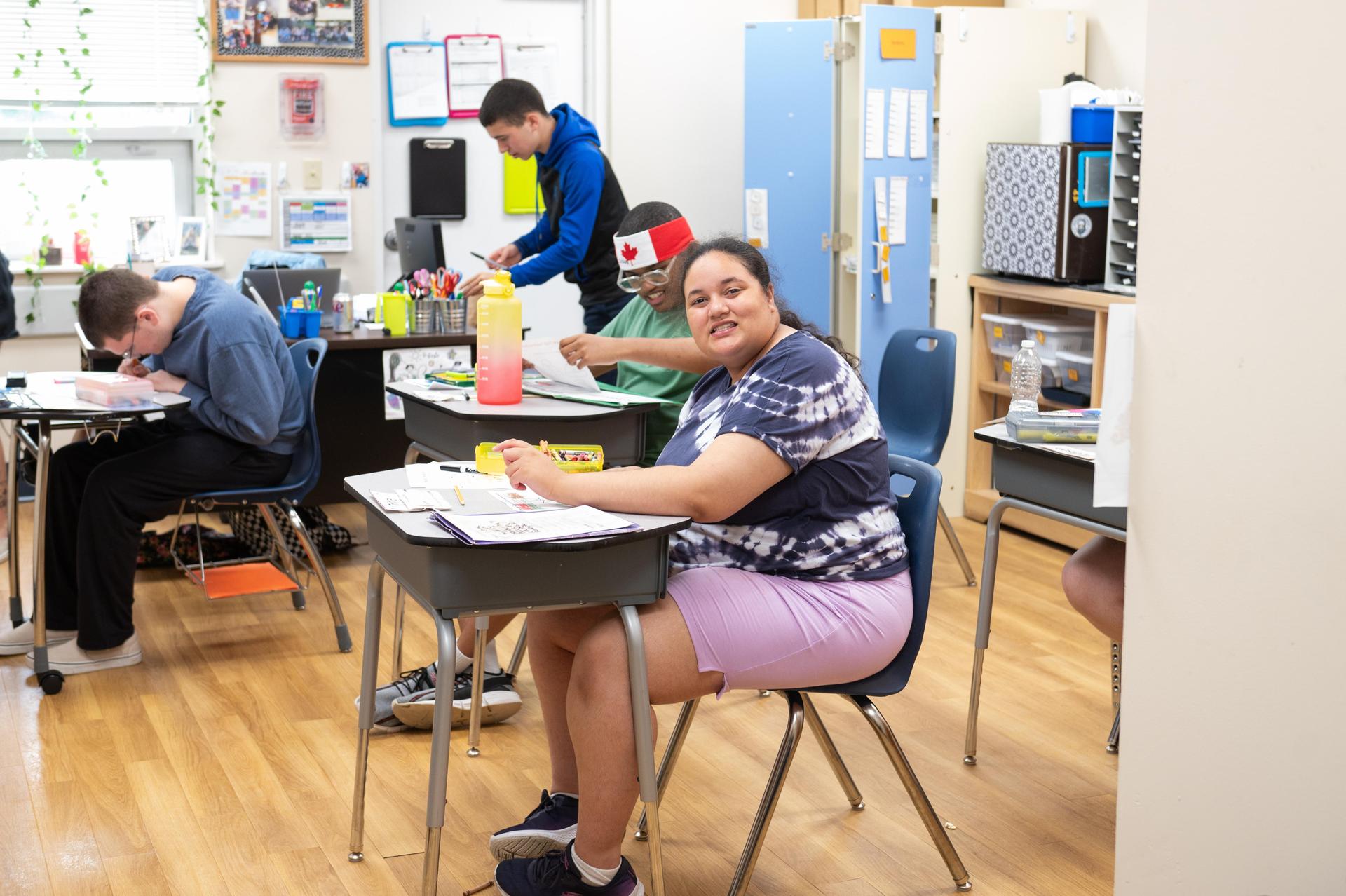 Student sitting at desk in classroom. 