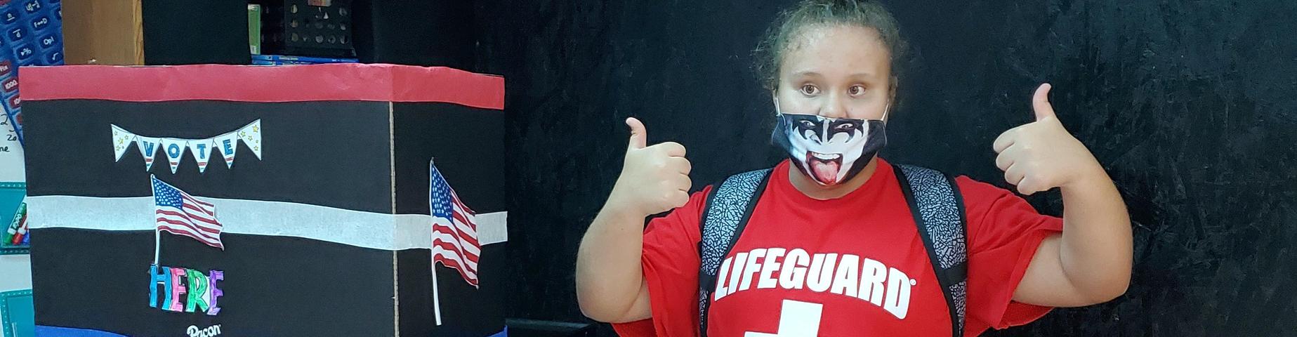 Student giving a thumbs up.