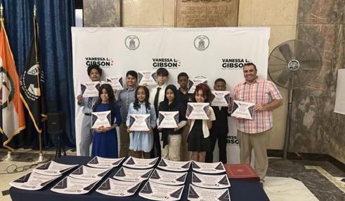 students from PS 121 with the teacher with their certificates