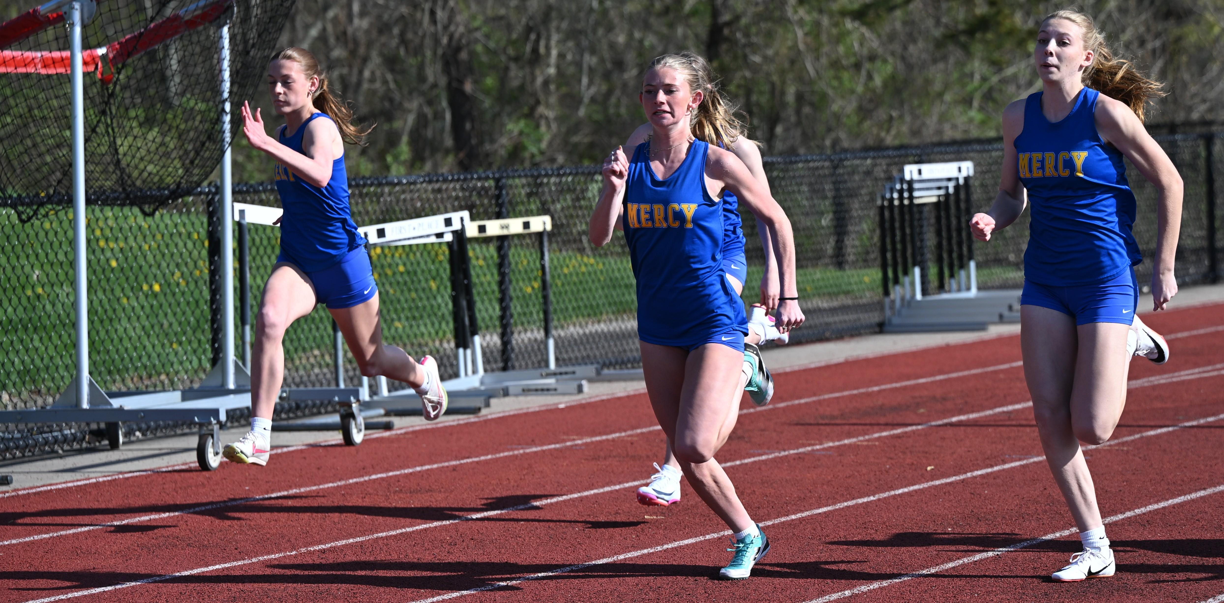 Track Athletes Running Together At A Meet