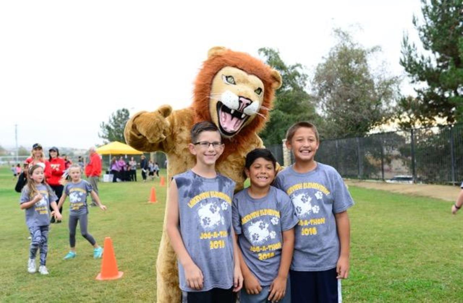 past jog-a-thon runners with lion mascot