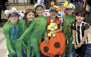 A team of elementary students in costumes at the Odyssey of the Mind competition.