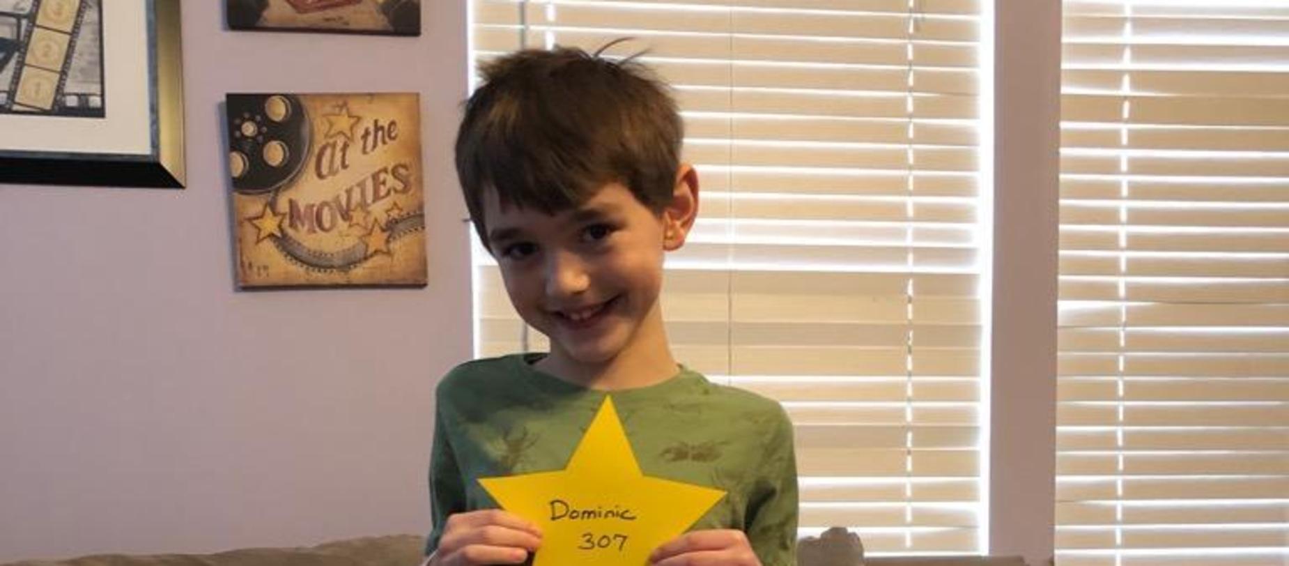 boy holding a star smiling for camera