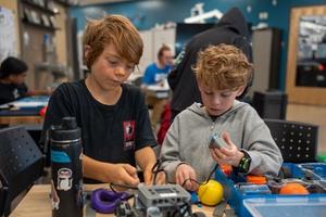 two elementary aged boys building with coding blocks