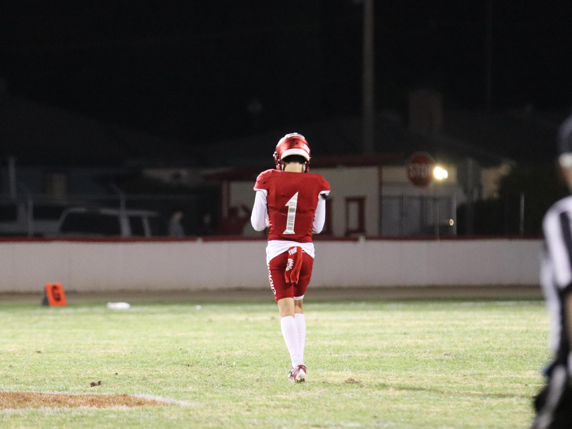 varsity football players in action against Riverdale