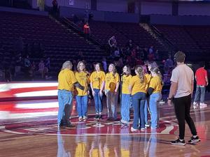 picture of the students singing, with a camera guy nearby