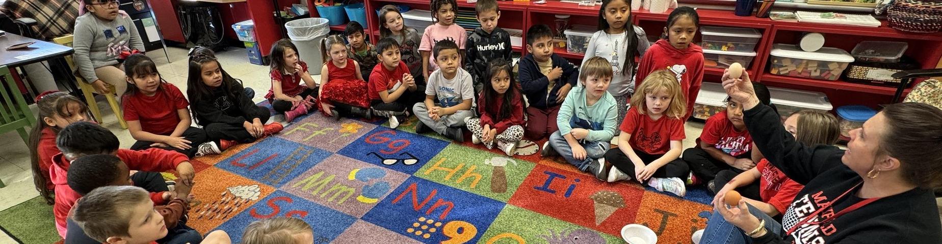 Students gather on a carpet to learn about Martin Luther King, Jr