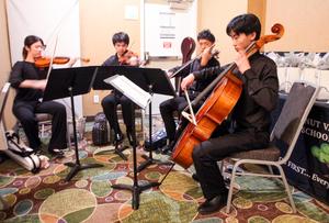 The Diamond Bar High School String Quartet perform while guests eat dinner.