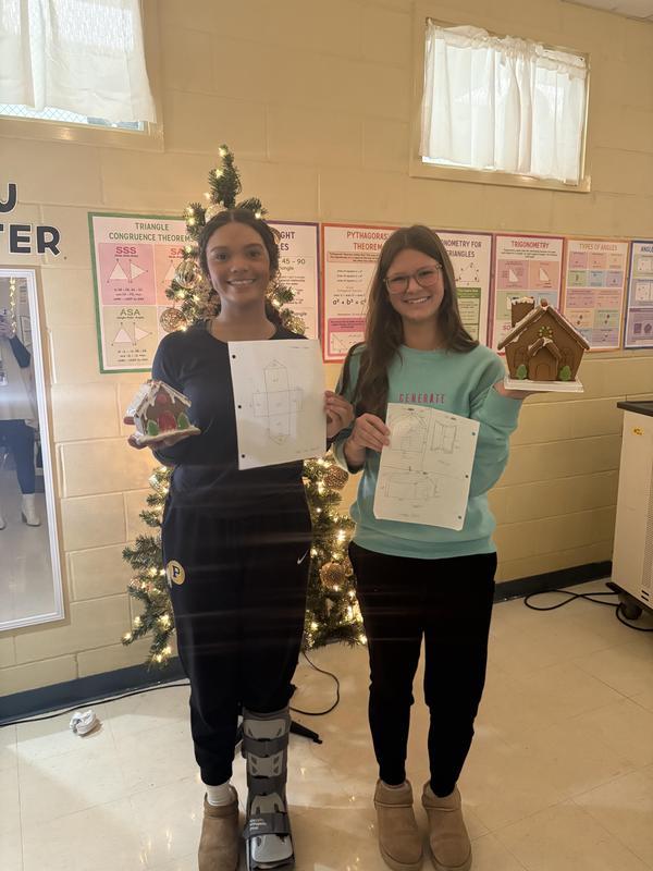 two students with gingerbread house