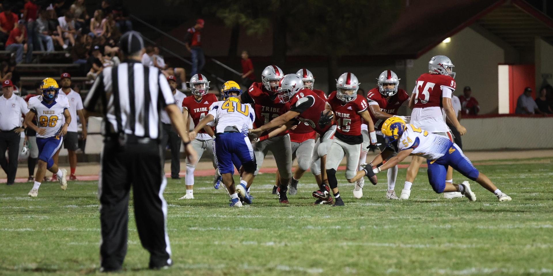 Varsity football players in action against Parlier 58