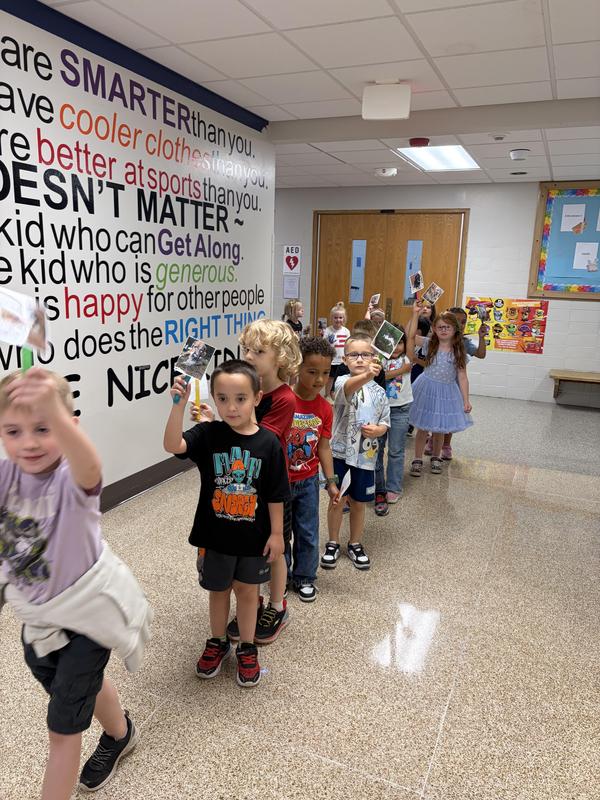 Students holding pictures of their pets