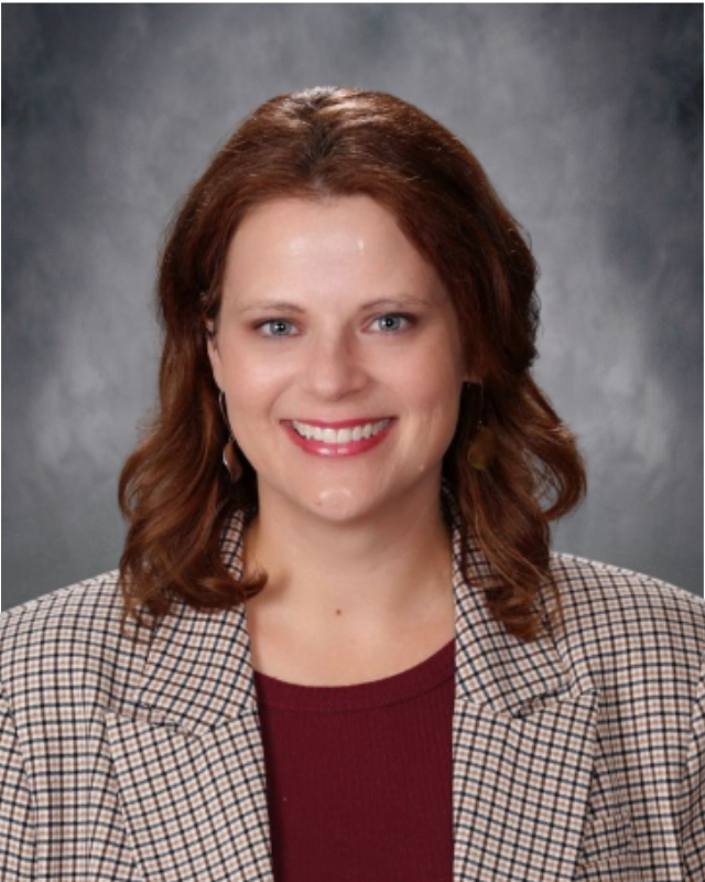 A woman smiling facing the camera.