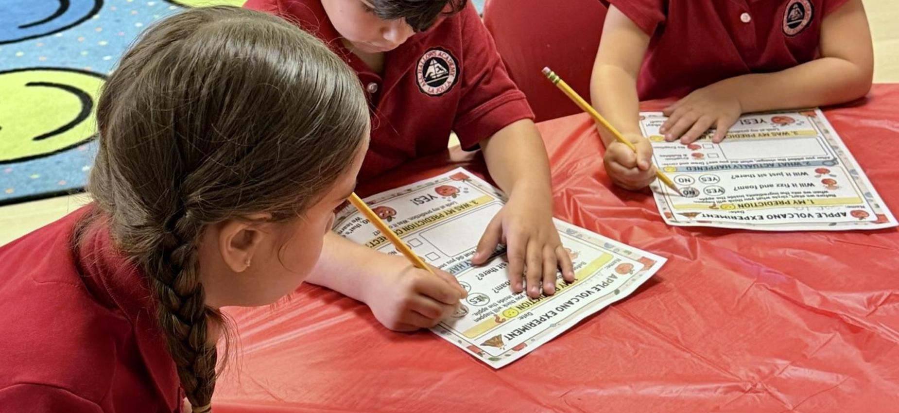 Kindergarten students sitting at table learning about apples