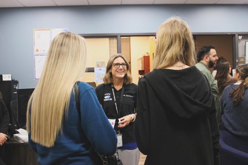 photo of counselor talking to parent and student