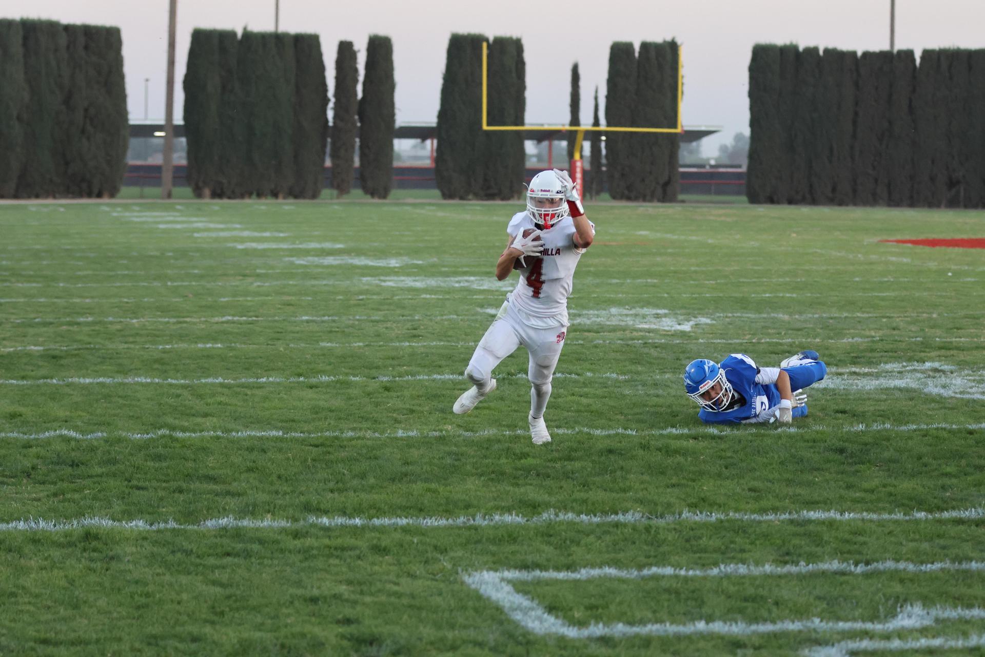 Junior Varsity football players in action against Caruthers