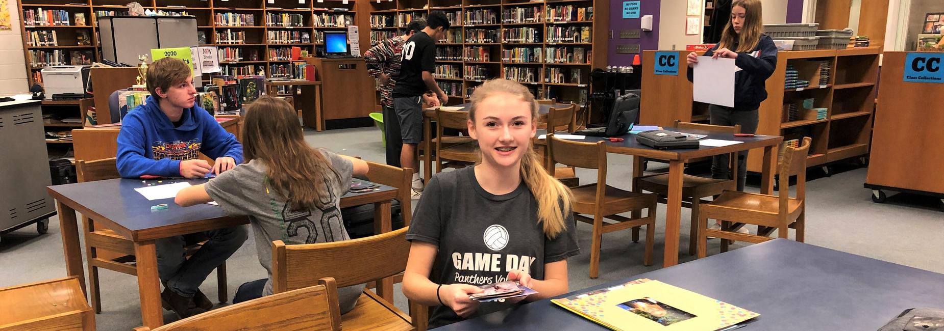 student making scrapbook
