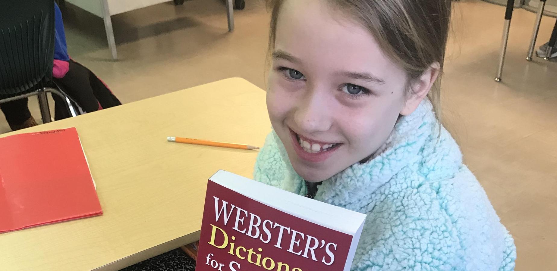 Maggie Jones displays dictionary donated by Rotary Club