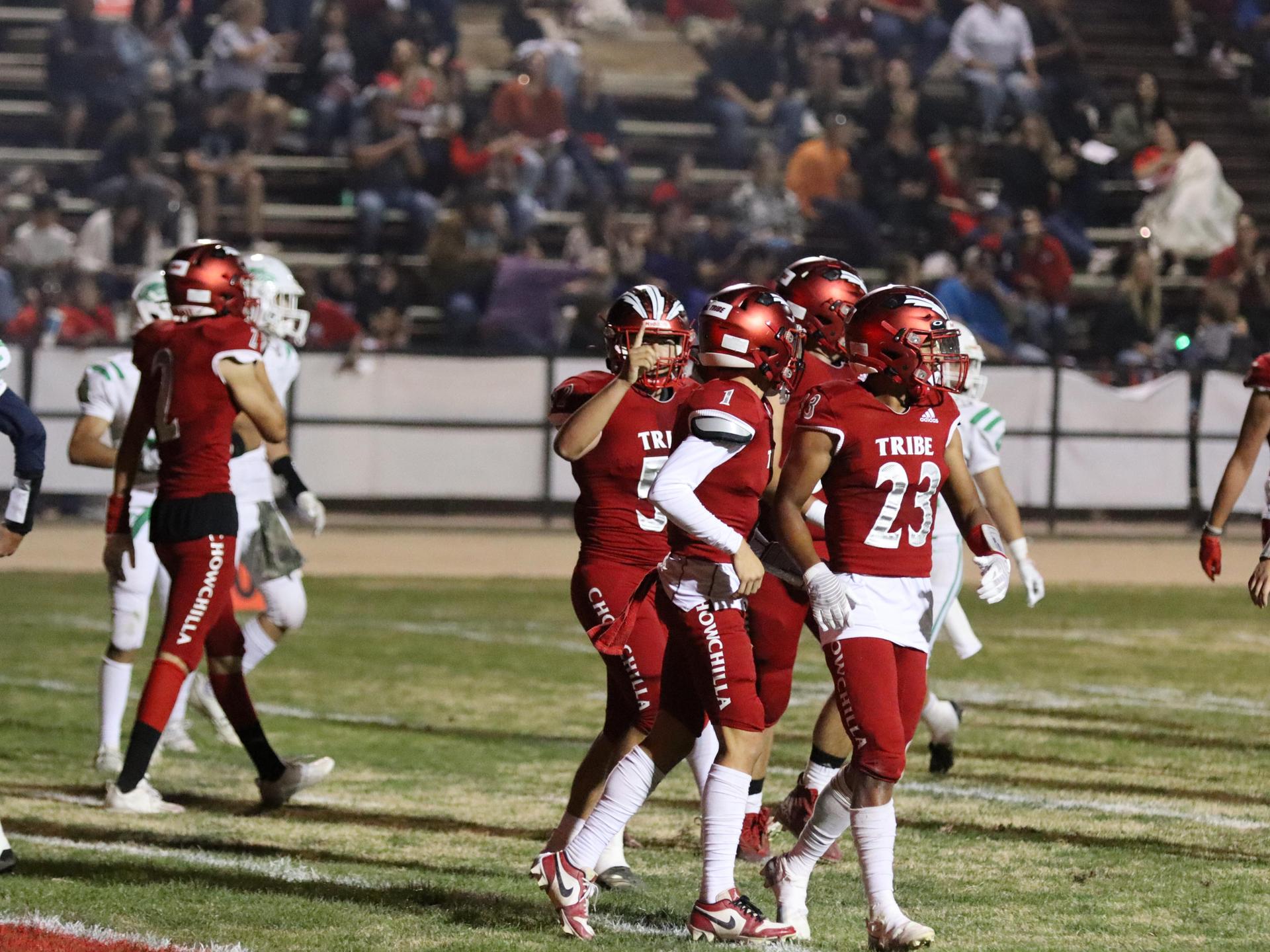 varsity football players in action against Riverdale