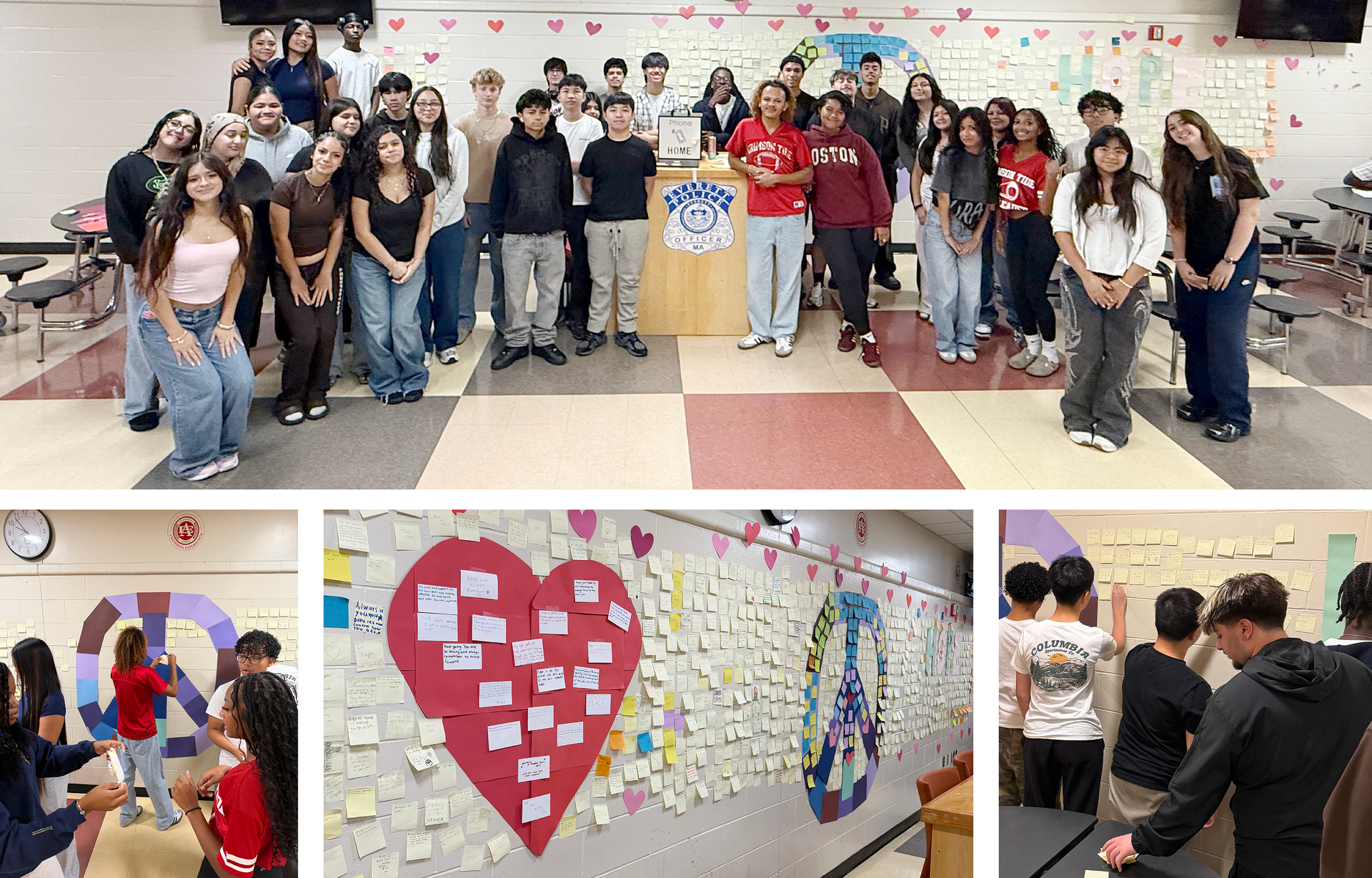 A diverse group of students posing together in a classroom with decorated walls.