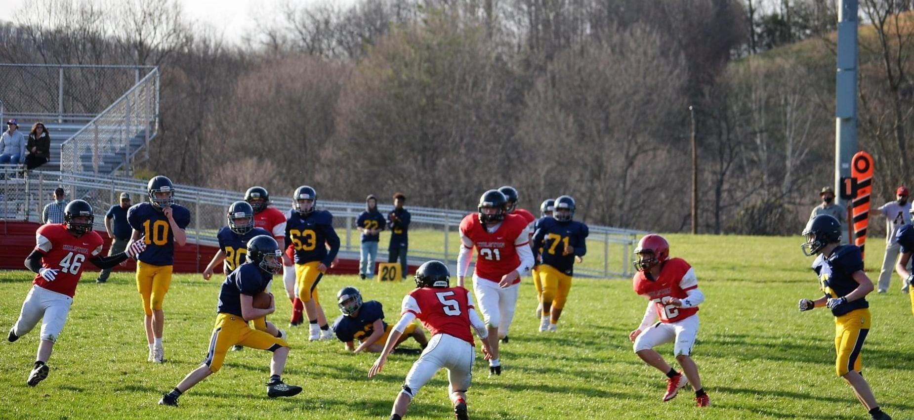 Two football teams play on a football field.