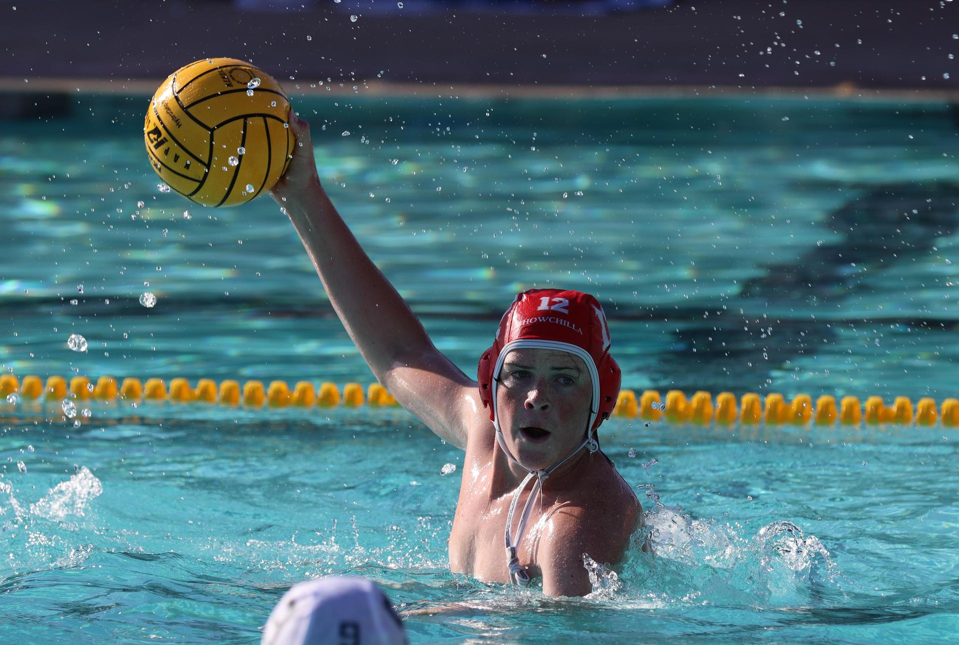 boys water polo players in action against hoover