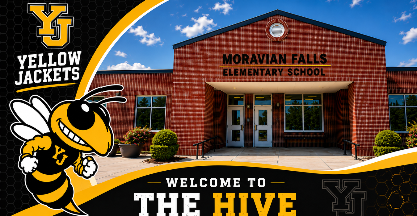 School entrance with a large bee mascot and welcoming signage.